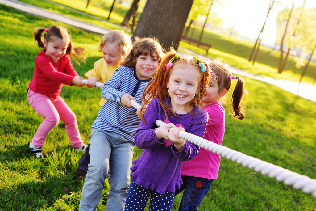 A group of kids playing tug-of-war