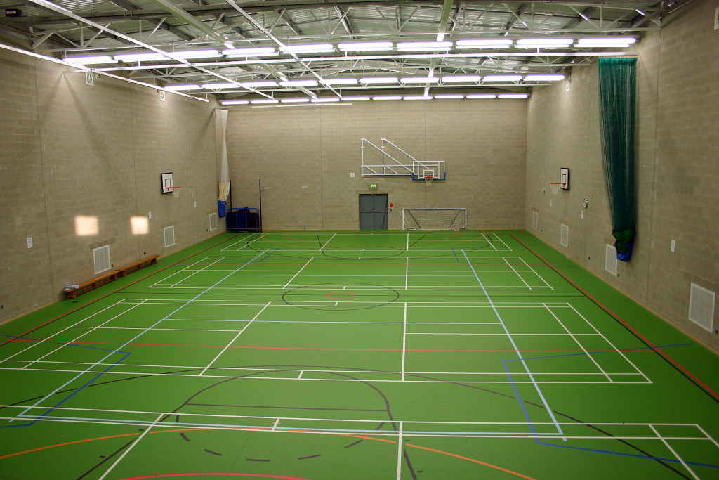 a multi-sports court with various linings on the green floor