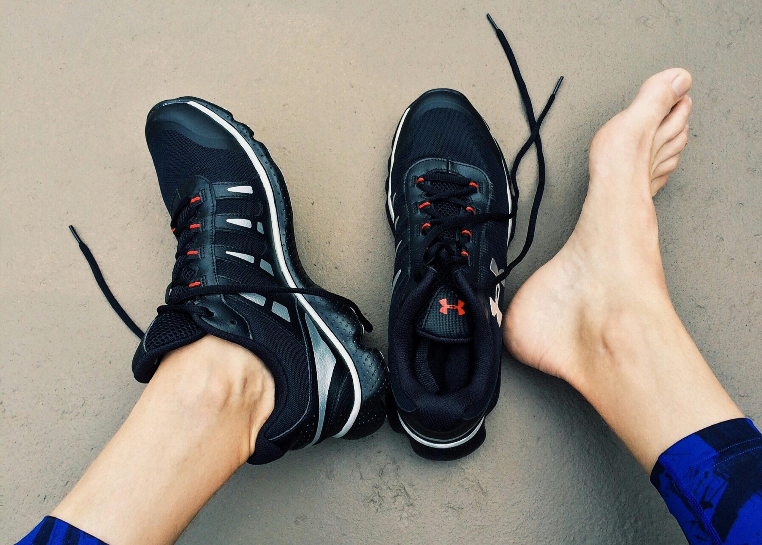 one foot bare and the other in a shoe, possibly due to swelling or discomfort